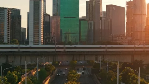 High speed bullet train moves across the city landscape of Hangzhou during the Stock Footage 340939977
