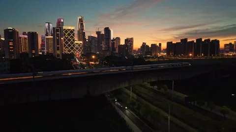 High speed bullet train moves across the city landscape of Hangzhou during the Stock-Footage 344880250