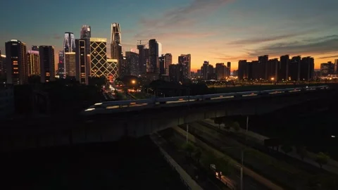 High speed bullet train moves across the city landscape of Hangzhou during the Stock-Footage 344880274