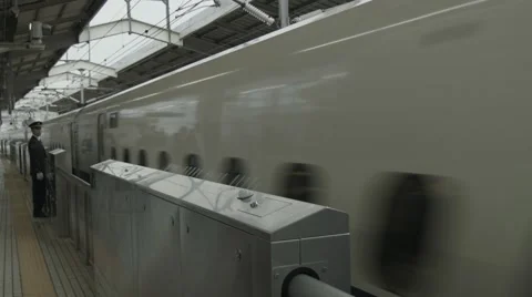 High-speed bullet train passing by railway station Stock Footage 51700010