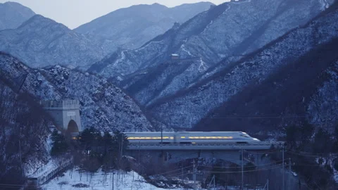 High Speed Bullet Train Passing through Juyongguan Great Wall in Snow Stock Footage 330987045