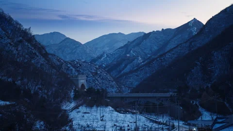 High Speed Bullet Train Passing through Juyongguan Great Wall in Snow Stock Footage 330987196