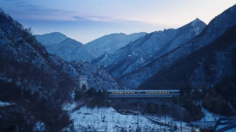High Speed Bullet Train Passing through Juyongguan Great Wall in Snow Stock Footage 330987218