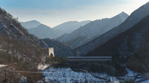 High Speed Bullet Train Passing through Juyongguan Great Wall in Snow Stock Footage 330987479