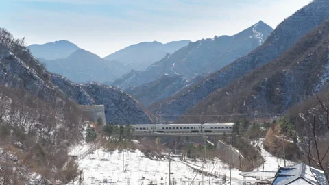 High Speed Bullet Train Passing through Juyongguan Great Wall in Snow Stock Footage 330987508