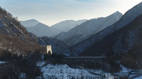 High Speed Bullet Train Passing through Juyongguan Great Wall in Snow Stock Footage 330987582