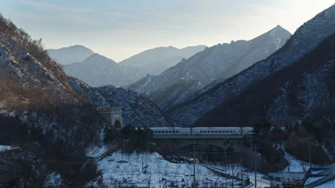 High Speed Bullet Train Passing through Juyongguan Great Wall in Snow Stock Footage 330987724