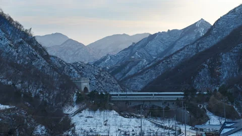 High Speed Bullet Train Passing through Juyongguan Great Wall in Snow Stock Footage 330987840