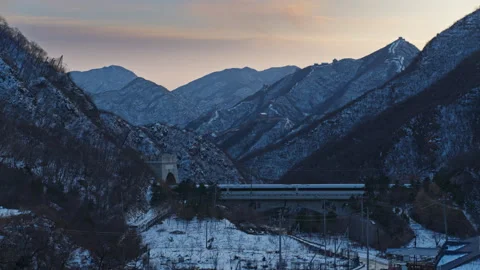 High Speed Bullet Train Passing through Juyongguan Great Wall in Snow Stock Footage 330988165