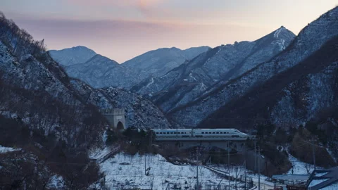 High Speed Bullet Train Passing through Juyongguan Great Wall in Snow Stock Footage 330988699