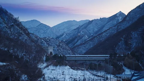 High Speed Bullet Train Passing through Juyongguan Great Wall in Snow Stock Footage 330988783
