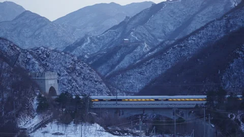 High Speed Bullet Train Passing through Juyongguan Great Wall in Snow Stock Footage 331003822