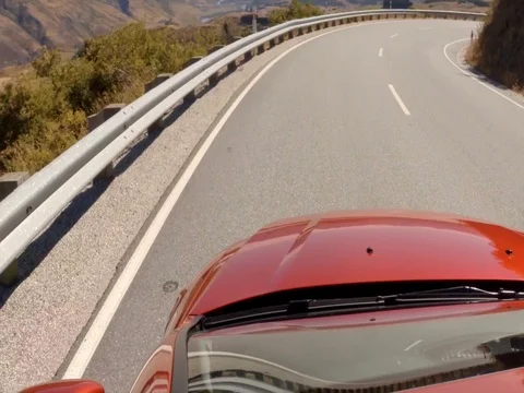 High speed car on curvy road in New Zealand Stock Footage