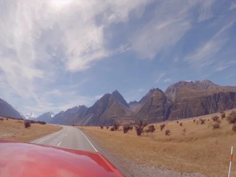 High speed car on long winding road in New Zealand Stock Footage 76269072