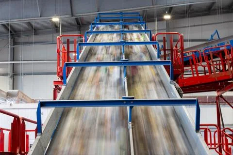 High speed conveyor system transporting waste in recycling plant Stock Photos