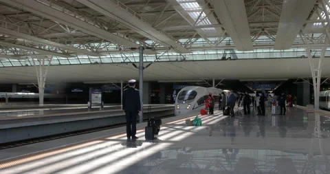High-speed CRH bullet train enters and stops at the platform Stock Footage 122117944