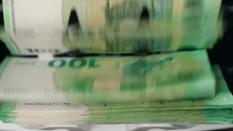 High-speed currency counting machine processes stacks of banknotes, showing Stock Footage 333979045