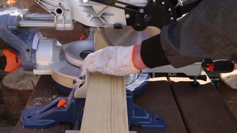 High-speed cutting circular saw. The man's hands are gloved. Stock Footage 160839431