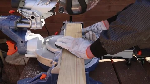 High-speed cutting circular saw. The man's hands are gloved. Stock Footage 160839440