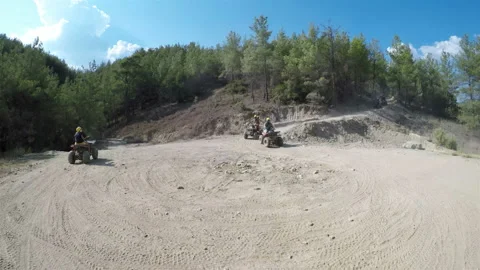 High-speed descent on Quad bikes on a mountain dusty road. First-person shooting Stock Footage 128183443
