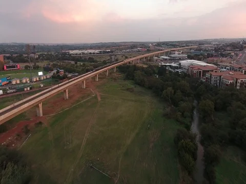 High speed drone chasing Gautrain train in Centurion in sunset Video stock 80721544