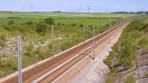 A high speed electric passenger train passes through the countryside of 库存影片 114164536