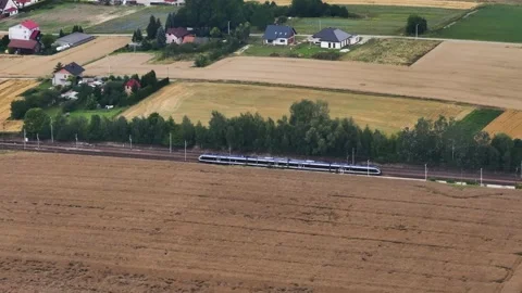 High speed electric passenger train traveling through rural Poland countryside Stock Footage 344111412