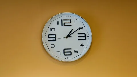 High-speed filming of running time on the wall-mounted clock. The wall is yellow 스톡 동영상 108580295