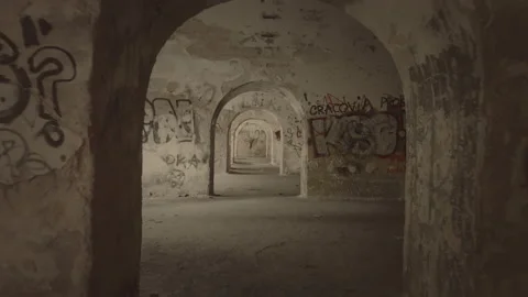 High speed forward dolly, zoom in through dark corridor with graffiti walls. Stock Footage 155755197