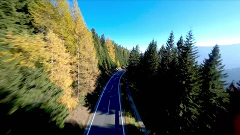 High-Speed FPV Chase: Drone Pursues Sports Car in Styrian Autumn Stock Footage 167942732