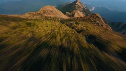 High-Speed FPV Drone Flight Over Narrow Rugged Mountain Ridge at Dusk Stock Footage 319295330