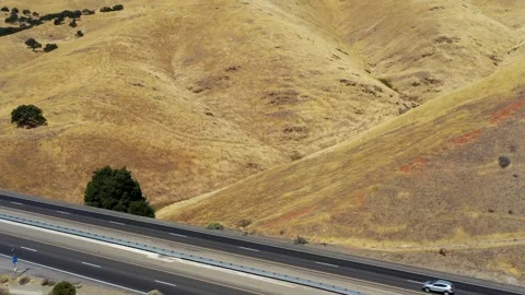 High Speed Highway Cuts Through a Remote Land Stock Footage 293808371