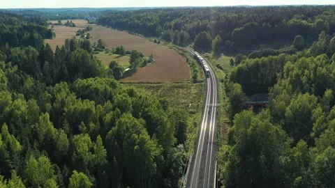 The high-speed intercity train moves on the railroad in the countryside. Stock Footage 138589118