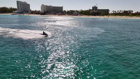 High-Speed Jet Ski Chase Aerial Drone Action Over Paradise Island Bahamas Stock Footage 295797704