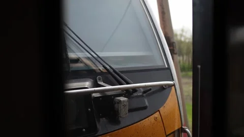 High speed modern train passes close by seen through narrow window wipers and re Stock Footage 307699776