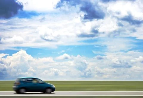 High-speed motion-blurred auto on rural highway Stock Photos