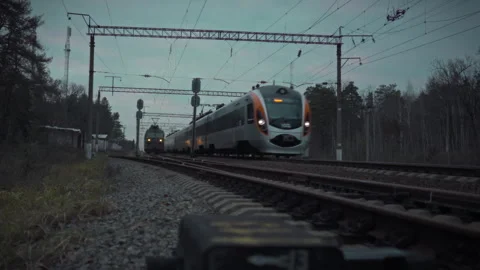 High-speed passenger train zooms along the rail track illustrating the dynam Stock Footage 331352212