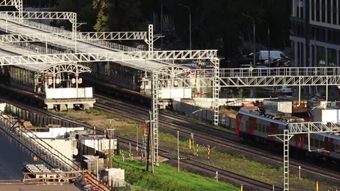 High-speed passenger trains arrive at a railway station in a major city Vídeos de archivo 161351659