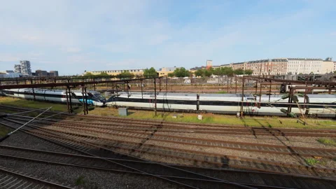 A high-speed train and multiple railway tracks at a large station in Copenhagen Stock Footage 348032357