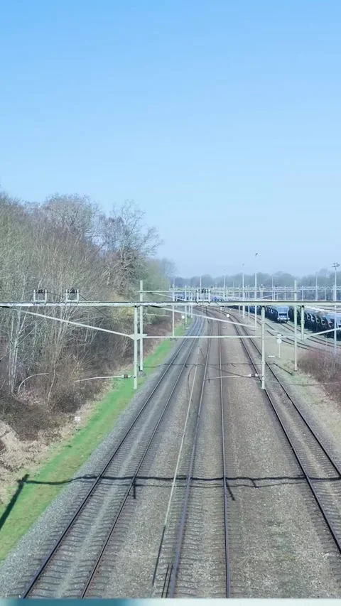 High-speed train approaching on electrified railway tracks Stock Footage 334423580