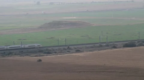 High speed train crosses the frame in a field. Stock Footage 8923689