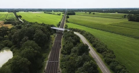 High-speed train crossing rural landscape montage Stock Footage 293942586