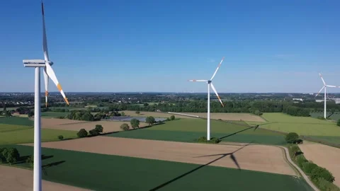 High speed train drives through a wind farm in Hamm, Germany Stock Footage