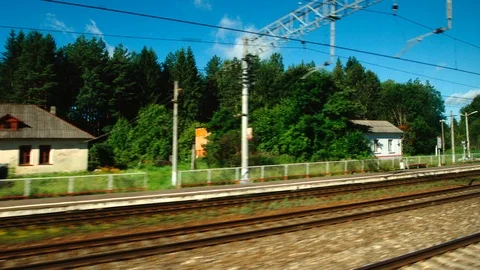 High-speed Train fast moves past a forest and a railway in the day Stock Footage 119355257