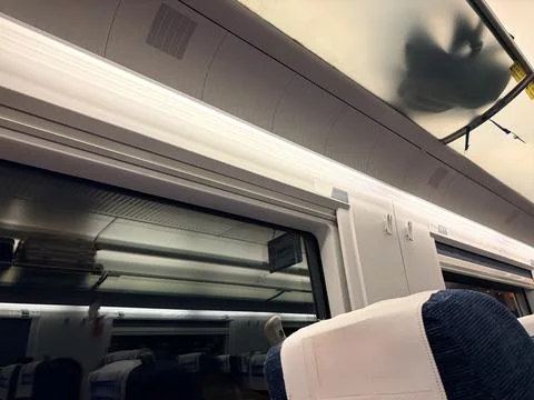 High-speed train interior with blurred landscape outside. Фото
