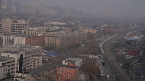 A high-speed train leaving Beijing on a pollution day Stock Footage 234370836