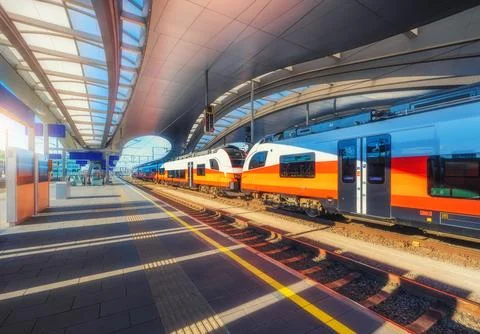 High speed train on the modern railway station at sunset in Graz, Austria. .. Stock Photos