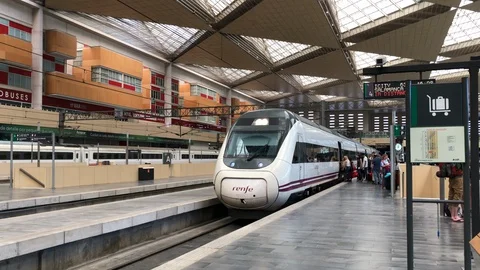 A high speed train modern in the station with tourists in Spain Stock-Footage 128898108