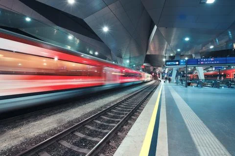 High speed train in motion on the railway station at night. Moving red mode.. Stock Photos