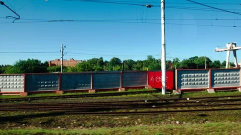 High-speed Train moves past a railway station in the summer day Vídeo Stock 119353991